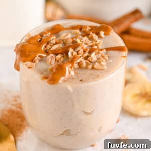 1000 Calorie Smoothies to Gain Weight and Build Muscle – served in a glass with calorie-dense peanut butter and protein granola on top.