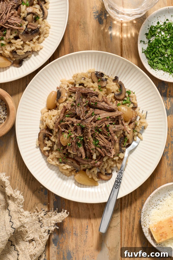 Red Wine Braised Beef Short Rib Risotto 9 Beef short rib risotto on a plate with fork.