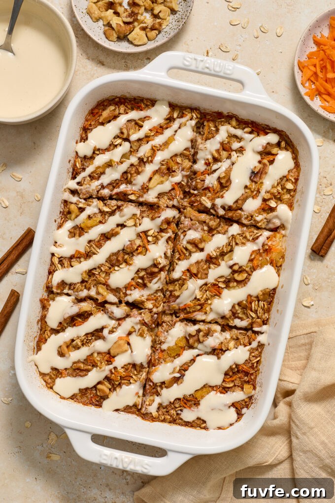 Carrot Cake Baked Oatmeal with Cream Cheese Glaze 2 Carrot Cake Baked Oatmeal topped with cream cheese glaze in baking dish.