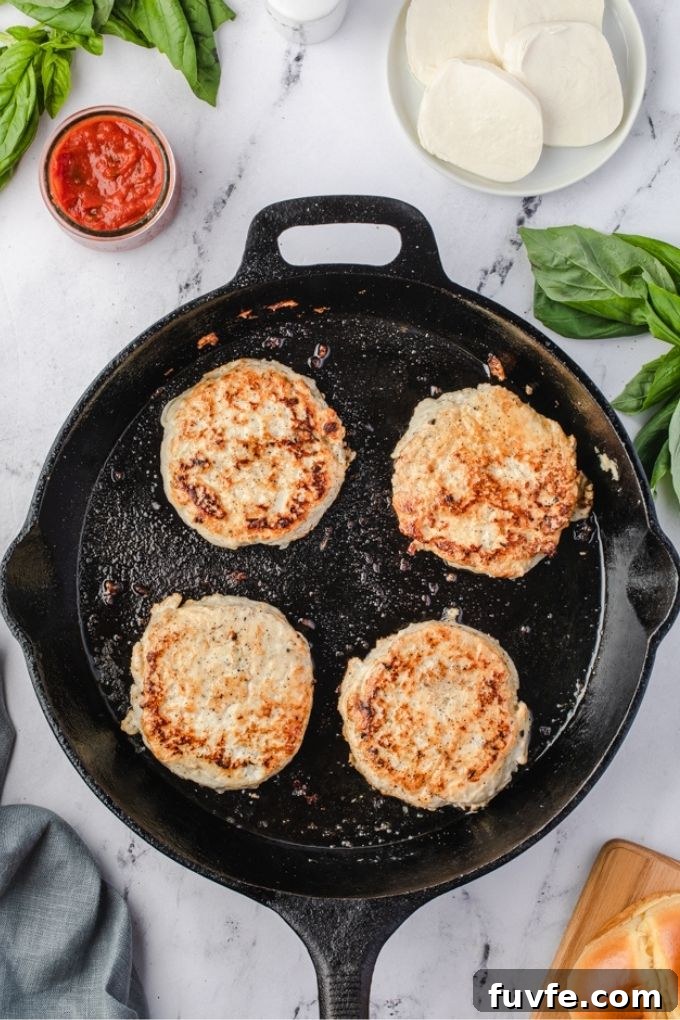 Ground chicken burgers in a cast iron skillet