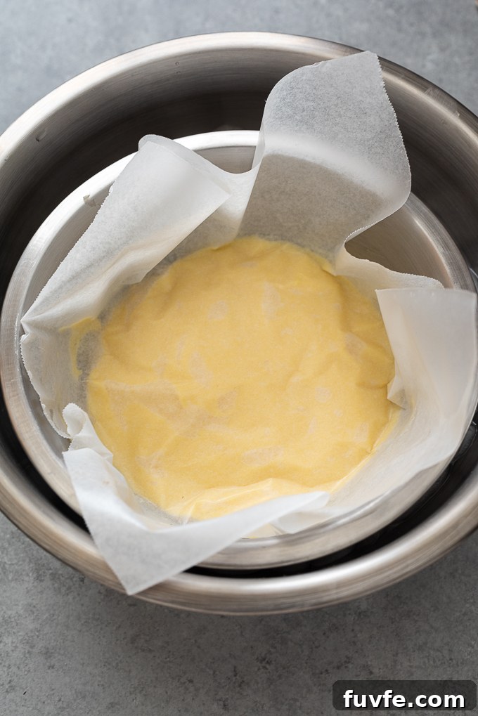 Pastry cream with buttered parchment paper over the top.