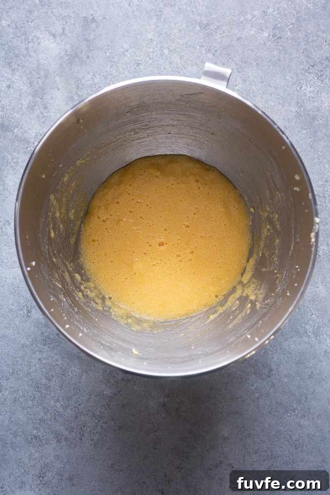 Eggs added to butter and sugar mixture.
