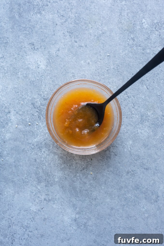Apricot jam with water in a small bowl.