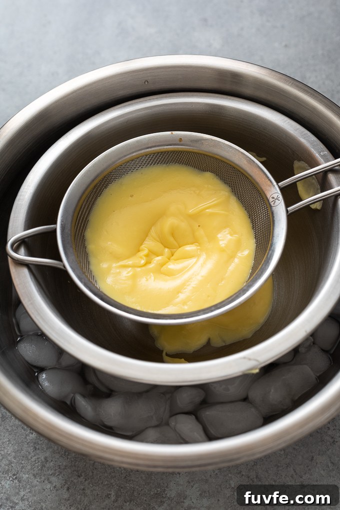 Pastry cream in mesh sieve.
