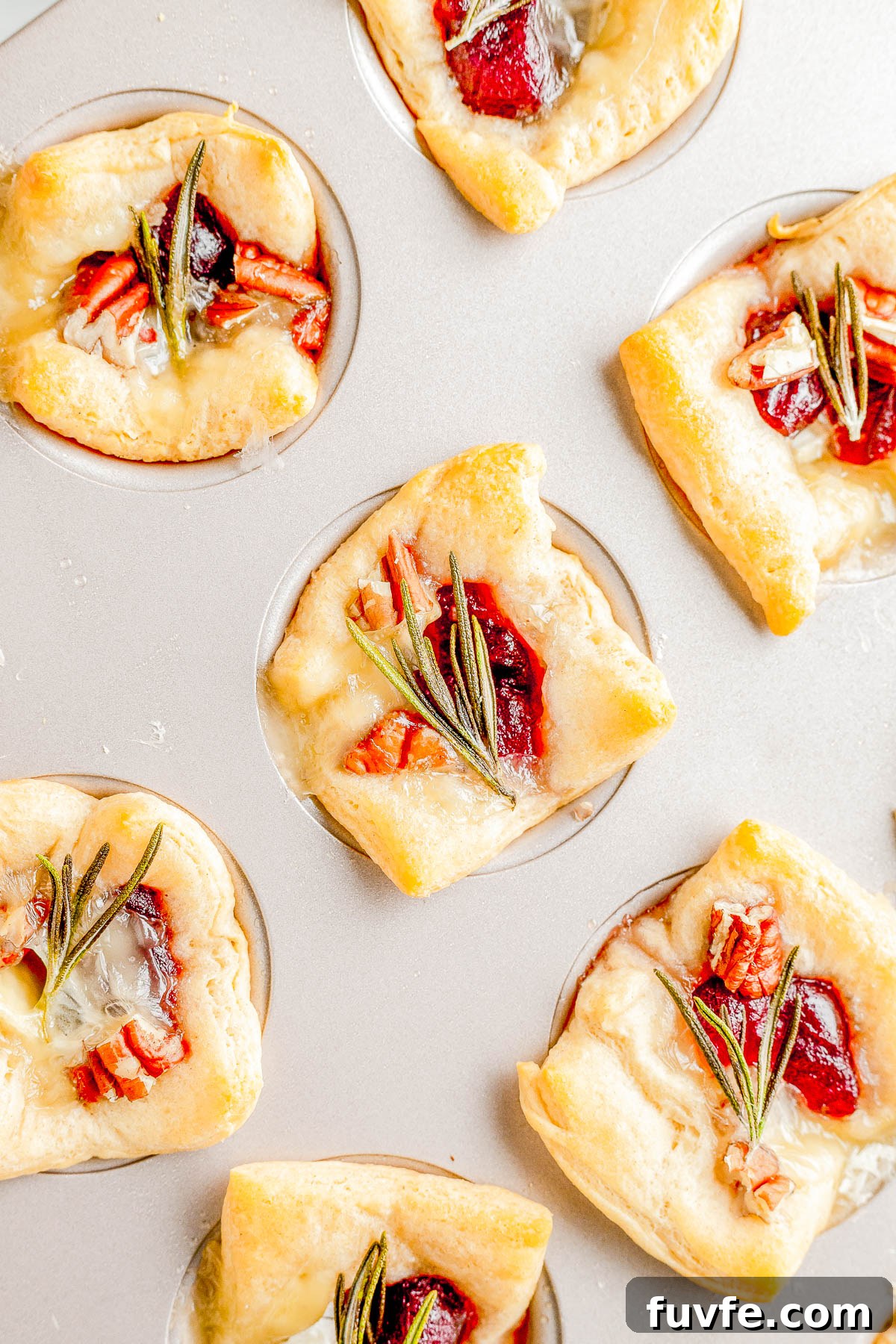 Baked Cranberry Brie Bites in a muffin pan. 