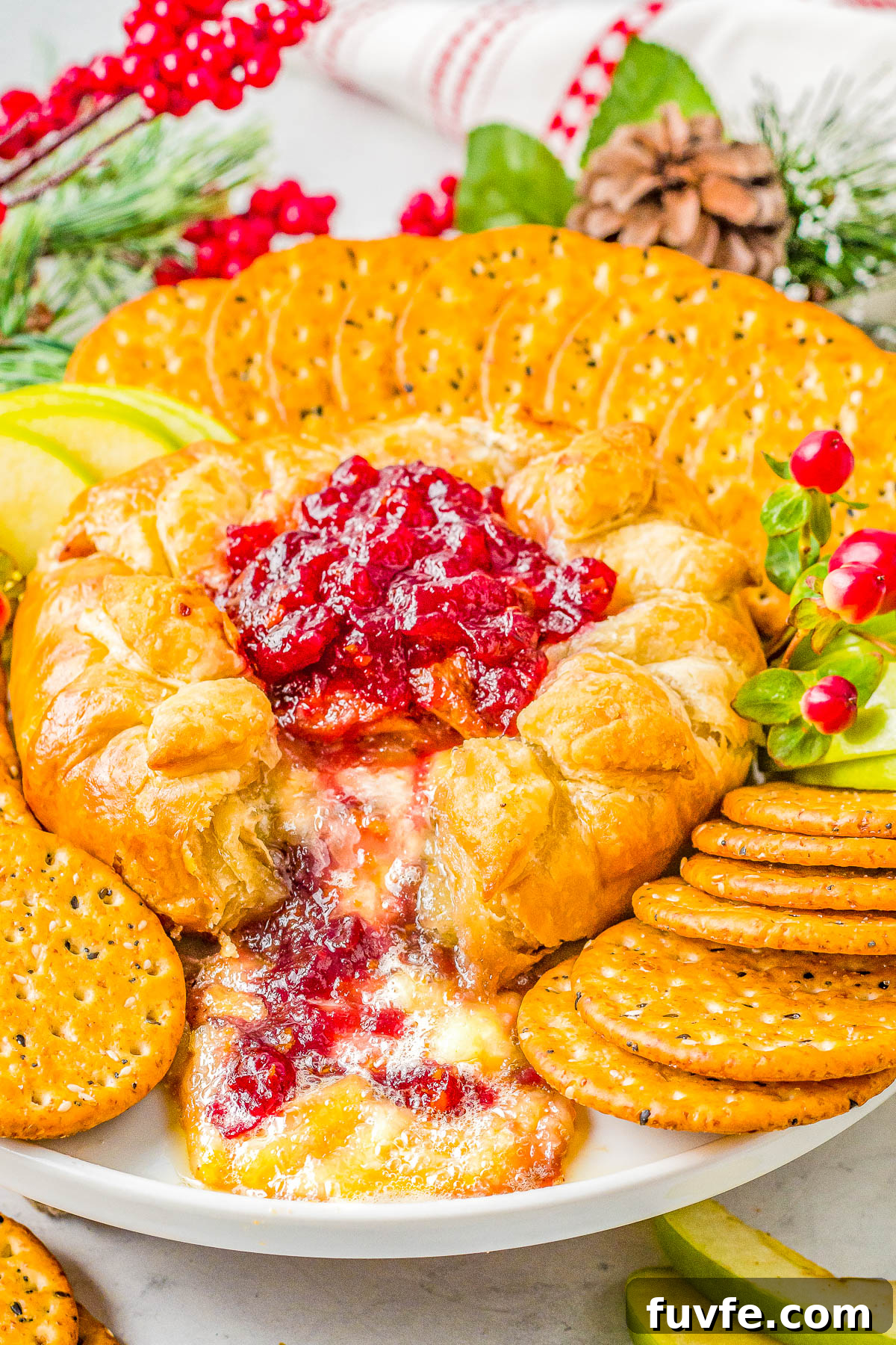 Baked brie in puff pastry surrounded by crackers. 
