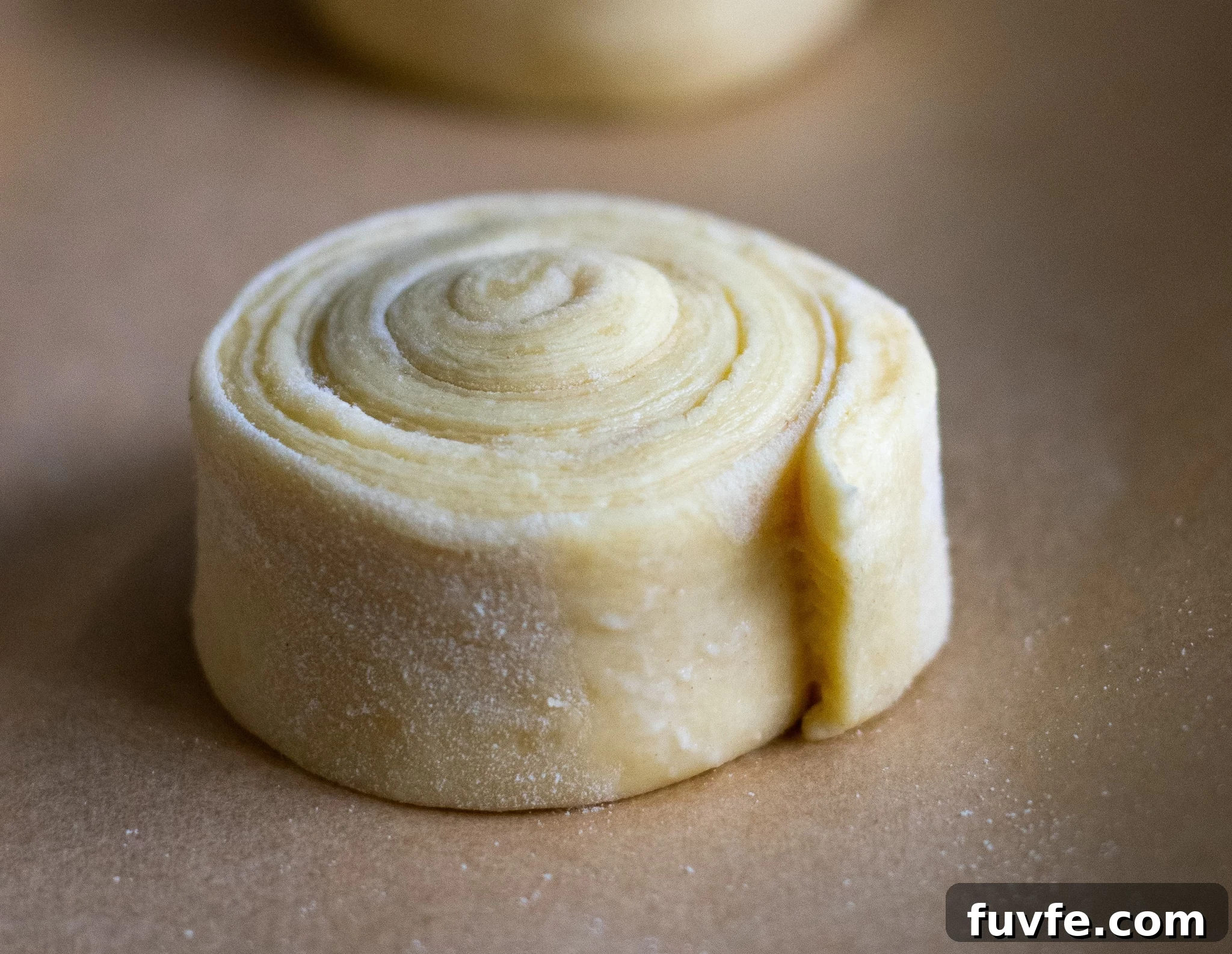 Danish pastry dough in a swirl shape.