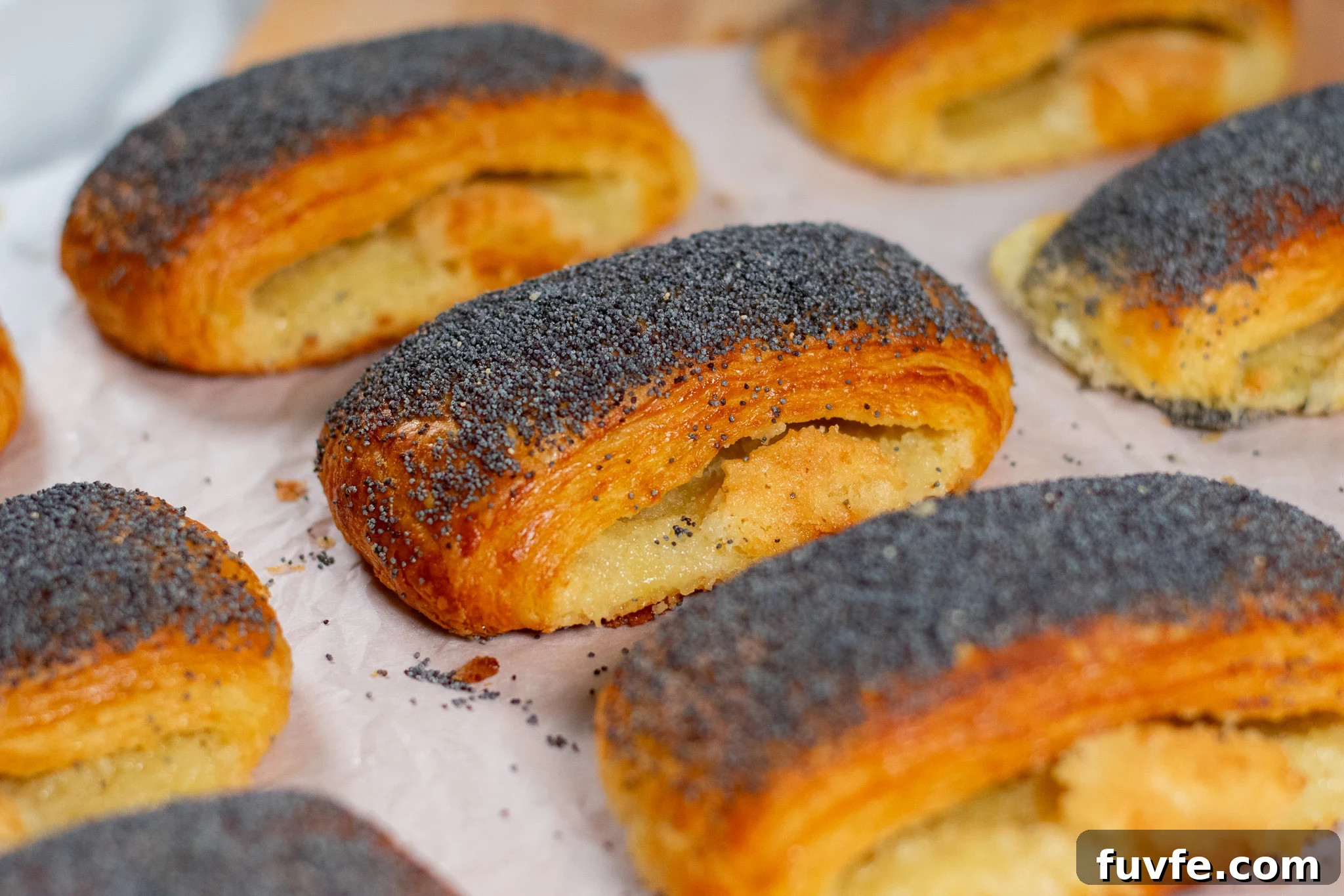 Poppy seed pastries on a cutting board.