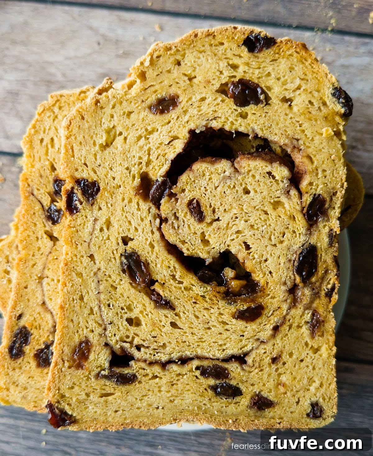 Gluten-Free Pumpkin Sandwich Bread with Cinnamon Swirl 10 The pumpkin raisin sandwich bread sliced open so you can see the swirls.