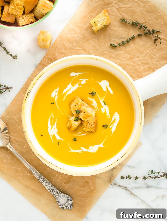 Creamy Butternut Squash, Potato and Leek Soup 3 Butternut squash soup in bowl with cream and croutons on top