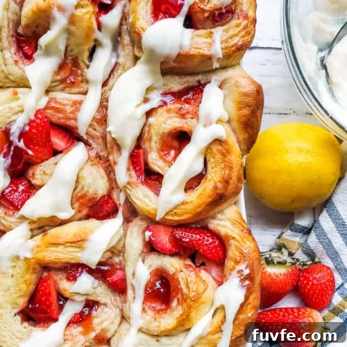 Overhead shot of strawberry rolls in a large baking dish.