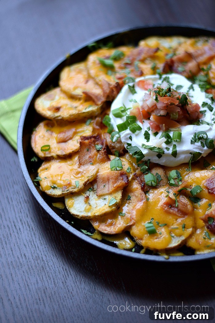 Irish nachos on a plate with sour cream