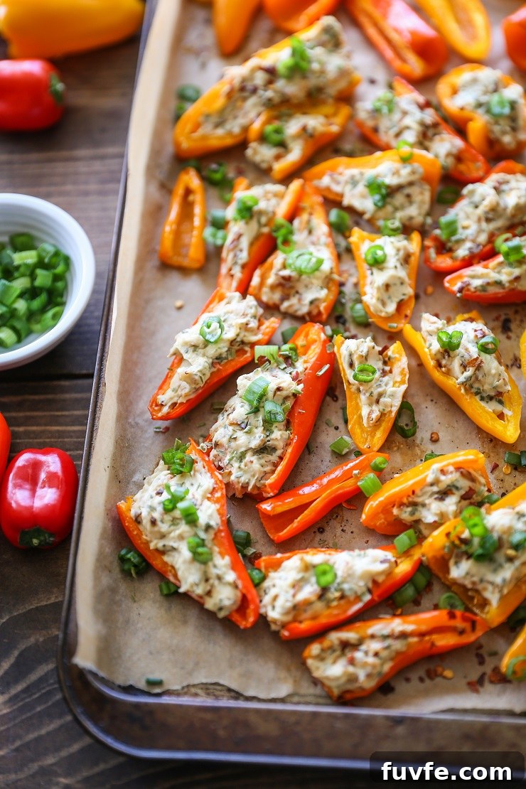 caramelized onion and cream cheese stuffed peppers on baking sheet
