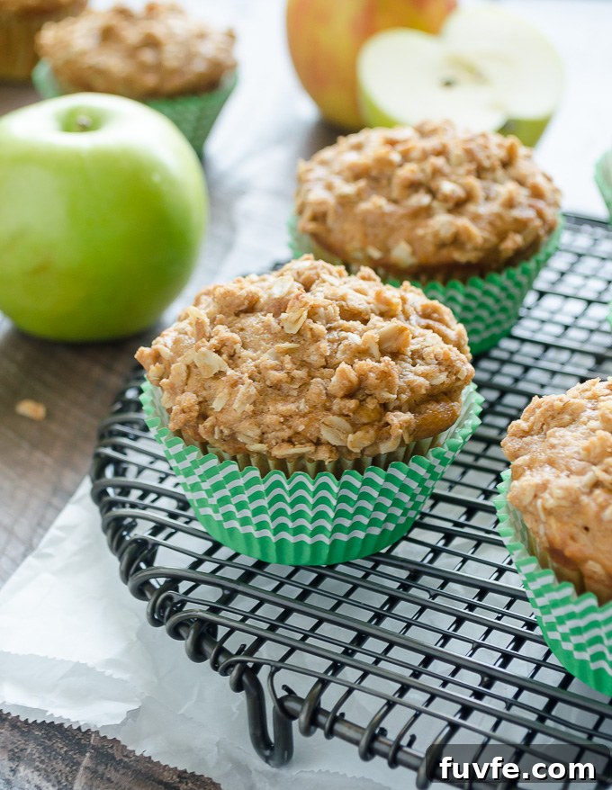 Moist Apple Oatmeal Muffins Recipe with Cinnamon 3 Apple crumble muffins on a wire rack