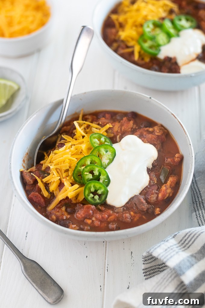 Crock pot turkey chili in a bowl with toppings