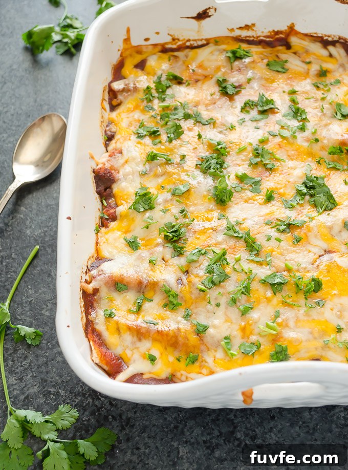 Sweet potato enchiladas in a baking dish with cilantro on top