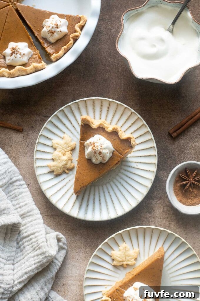 Chai Pumpkin pie with maple syrup on a plate.