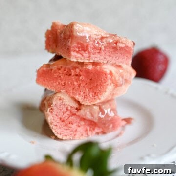 stack of strawberry brownies on a plate.