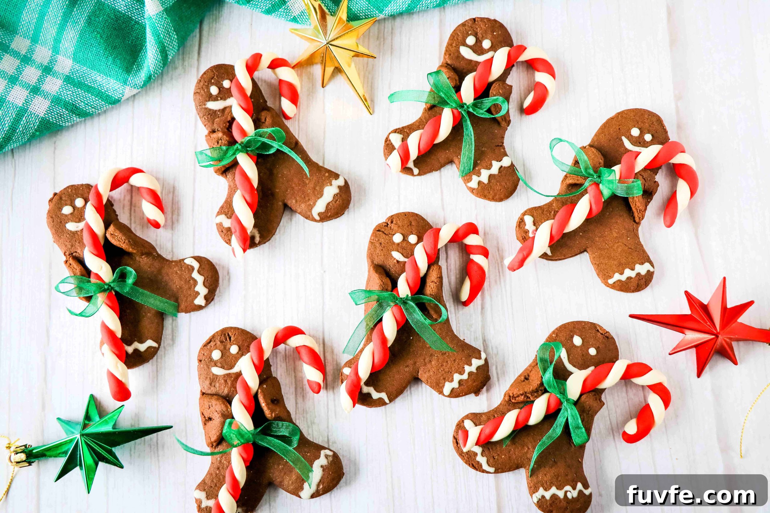 29 Christmas Baking Ideas for Home Bakers Who Love a Busy Oven 16 Gingerbread cookies with candy canes on a table.