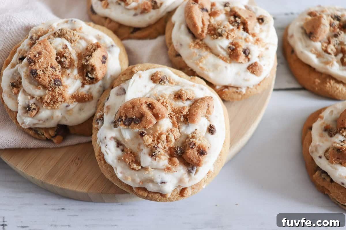 29 Christmas Baking Ideas for Home Bakers Who Love a Busy Oven 30 Frosted chocolate chip cookie cookies on a wooden cutting board.