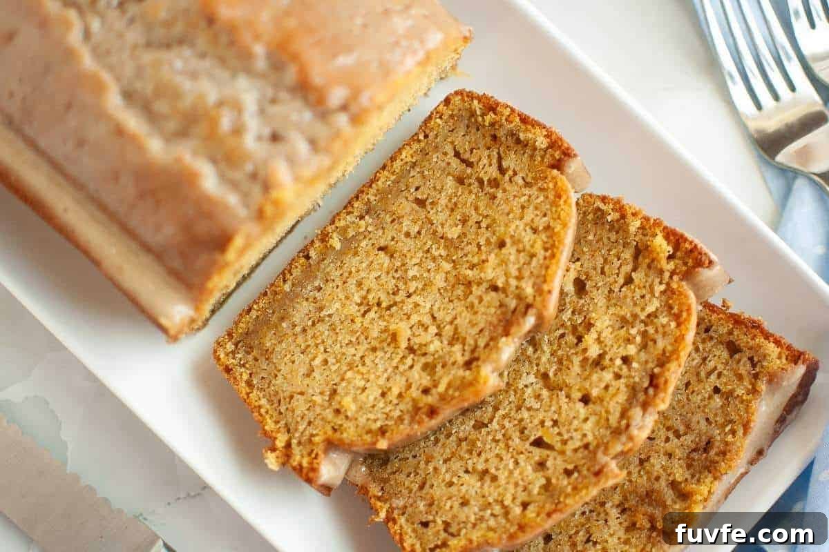 29 Christmas Baking Ideas for Home Bakers Who Love a Busy Oven 6 Three slices of Butternut Squash Loaf with Spiced Icing beside the remaining loaf bread on a plate.