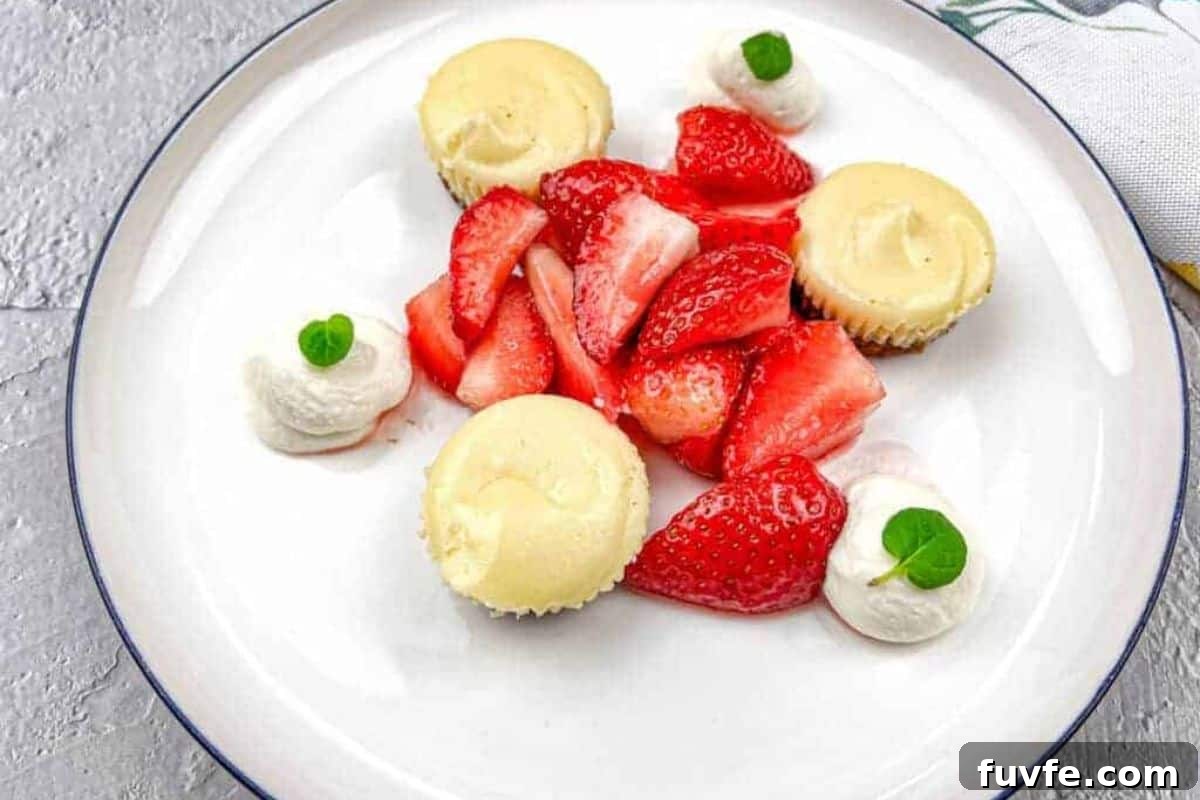 29 Christmas Baking Ideas for Home Bakers Who Love a Busy Oven 7 A white plate with strawberries and mini biscoff cheesecakes.