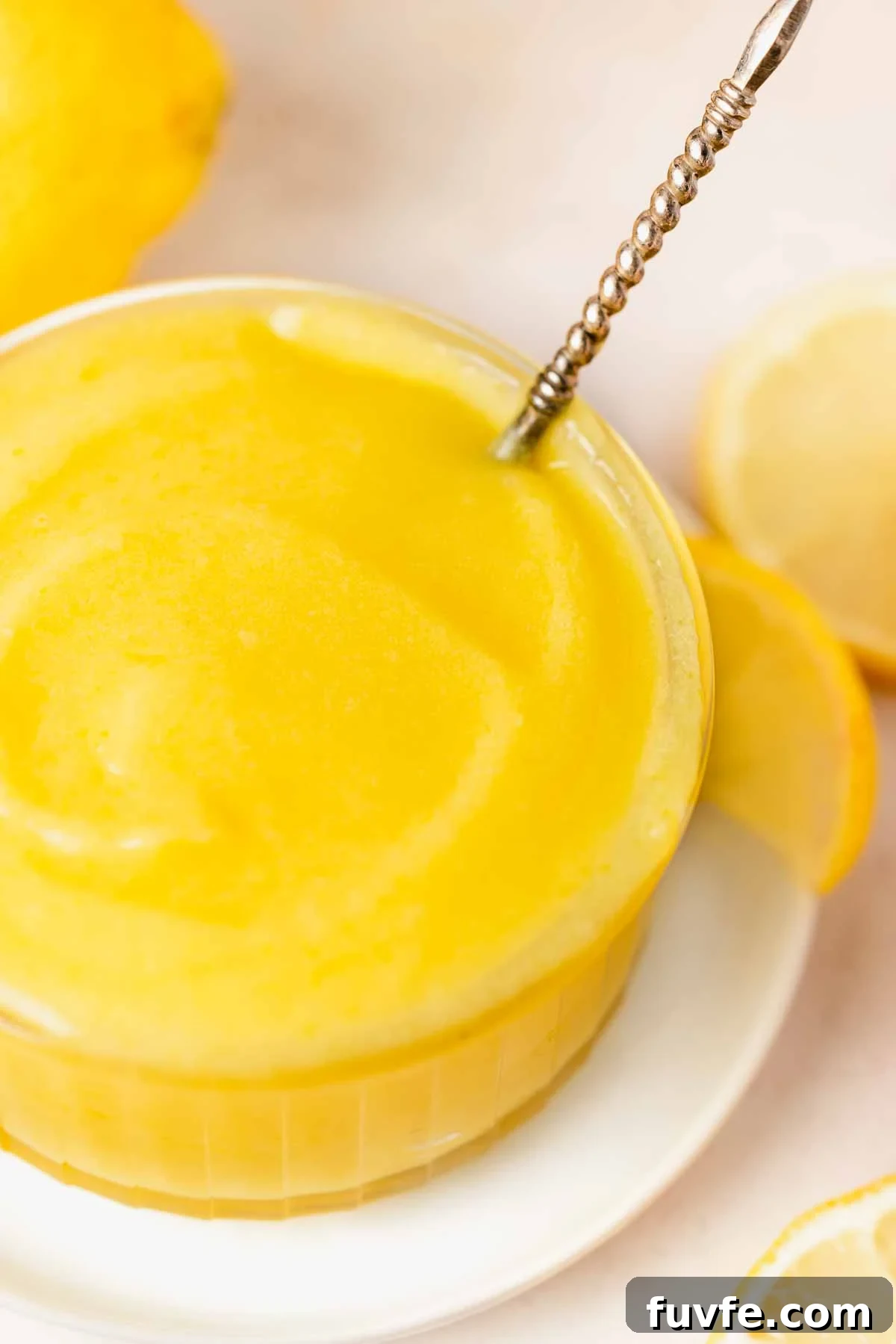 Homemade Lemon Curd Recipe: Smooth, Tangy, and Spreadable 3 closeup of lemon curd texture in bowl with spoon