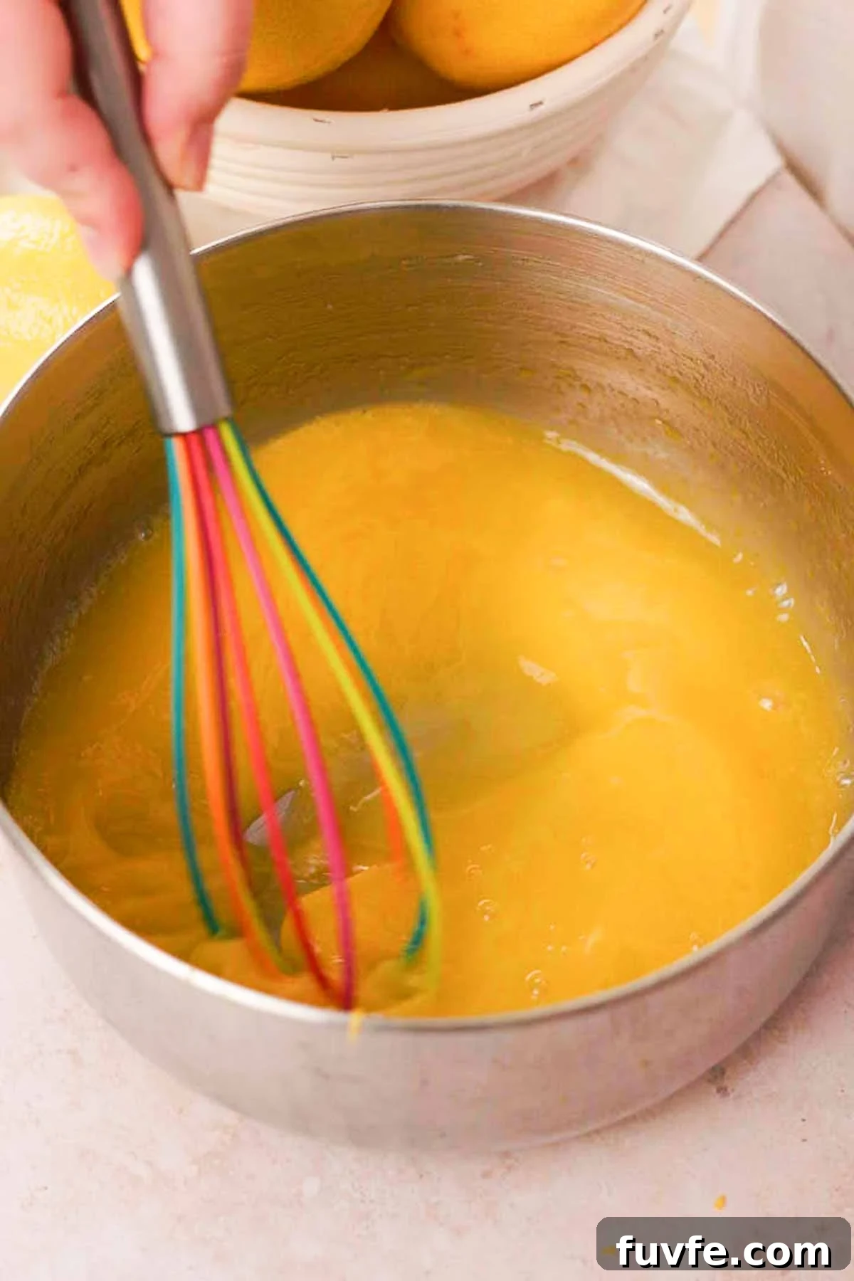 Homemade Lemon Curd Recipe: Smooth, Tangy, and Spreadable 5 whisking lemon curd ingredients in a saucepan