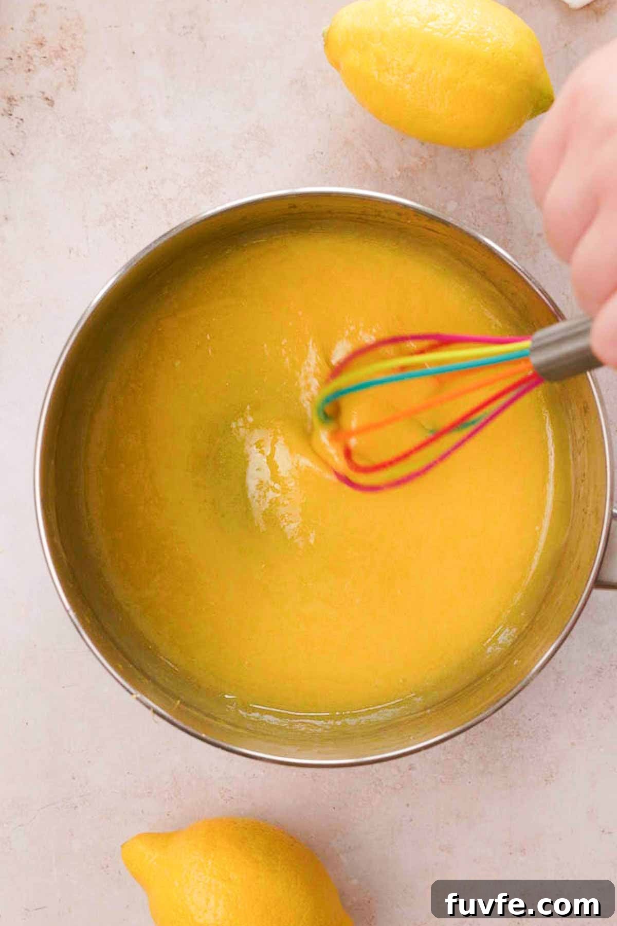 Homemade Lemon Curd Recipe: Smooth, Tangy, and Spreadable 6 whisking cooked lemon curd in saucepan