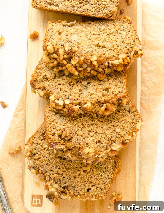 One-Bowl Banana Nut Bread Recipe (No Mixer) 7 Slices of banana walnut bread on a cutting board