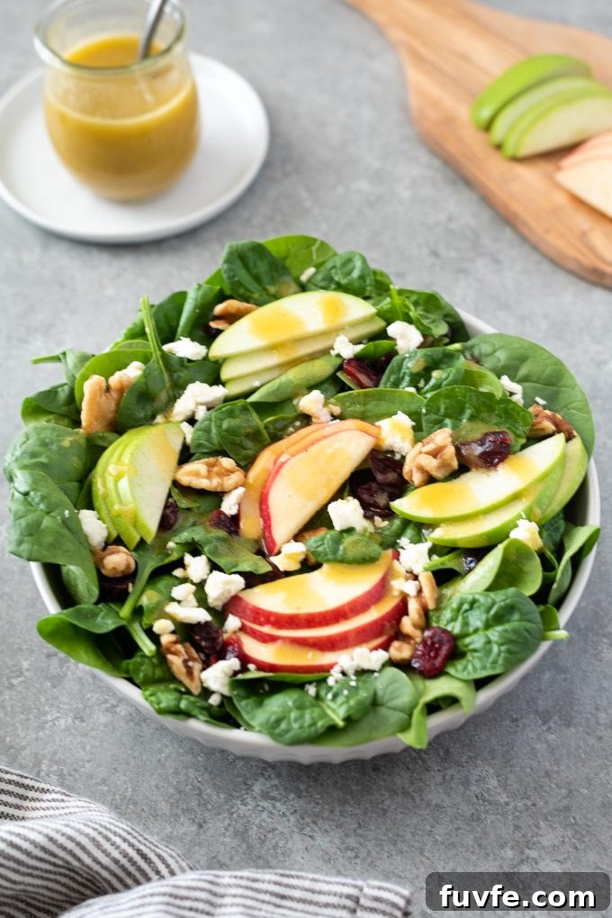 Crisp Spinach and Apple Salad with Feta and Walnuts 6 Close up of Spinach Apple Salad in white bowl