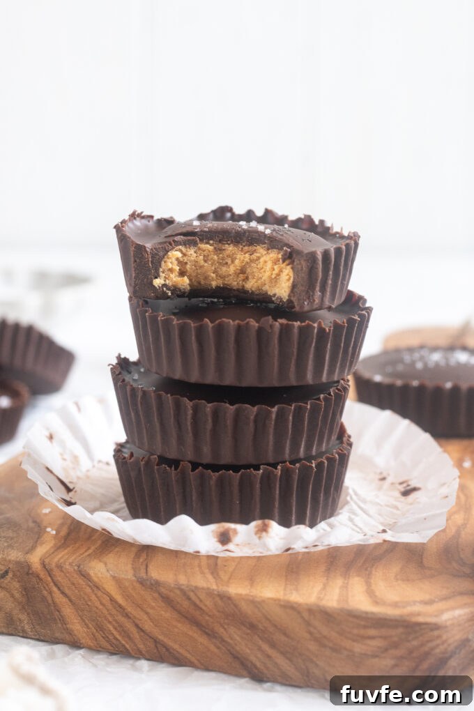 Homemade Protein Peanut Butter Cups 2 Protein peanut butter cups stacked up on a cutting board.
