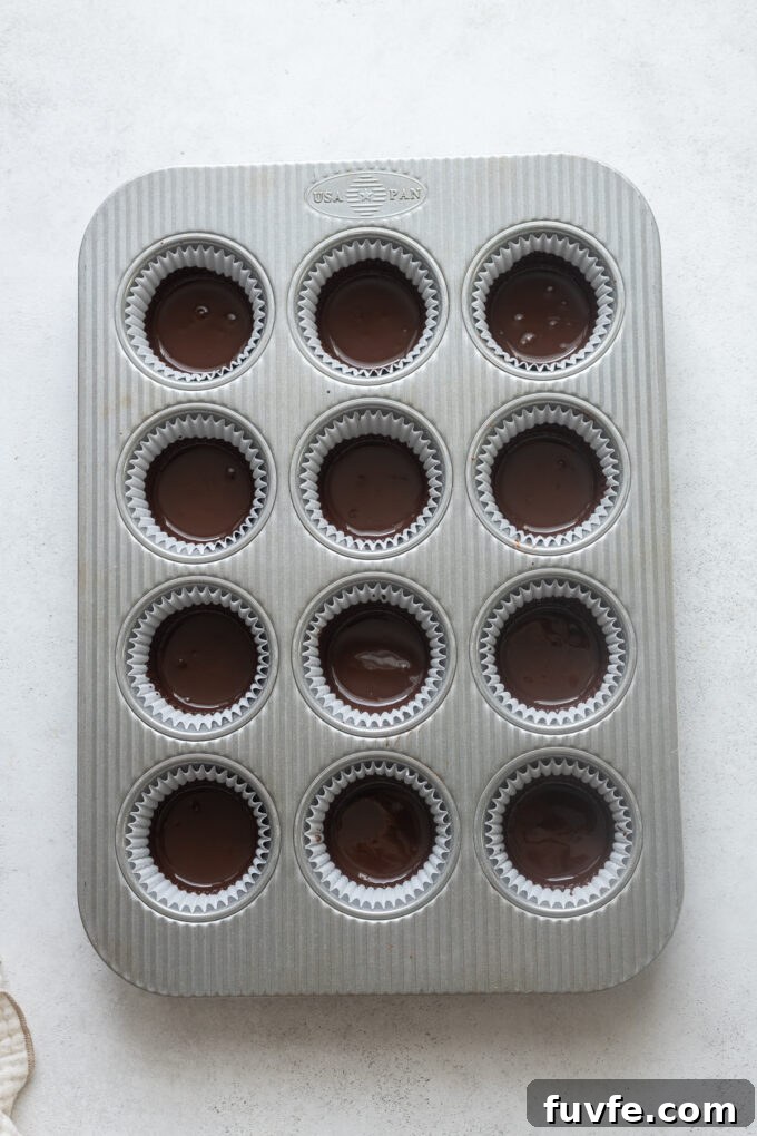 Homemade Protein Peanut Butter Cups 8 Melted dark chocolate in bottom of paper liners for peanut butter cups.