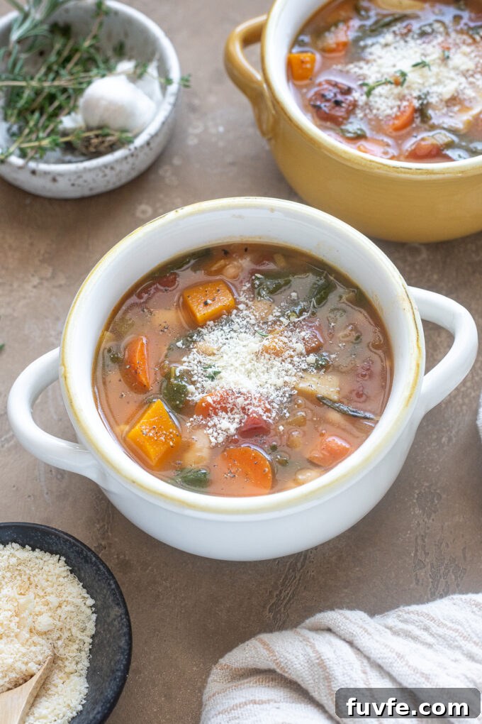 Comforting Autumn Vegetable Soup with Roasted Roots 9 Fall vegetable soup in a bowl with parmesan cheese.