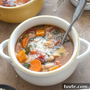 Comforting Autumn Vegetable Soup with Roasted Roots 10 Bowl of Autumn Vegetable Soup topped with parmesan cheese.