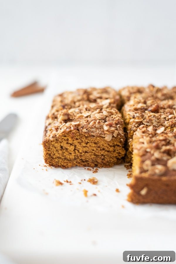 Pumpkin Coffee Cake Recipe with Oat Pecan Streusel 6 pumpkin coffee cake sliced into squares on a marble board