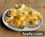 An easy chicken dinner casserole made with red lobster cheddar bay biscuit mix, rotisserie chicken, frozen veggies, chicken broth, soup, and milk. An amazing comfort food recipe for a large family with kids.