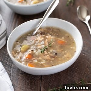 Crockpot turkey wild rice soup in a bowl with spoon
