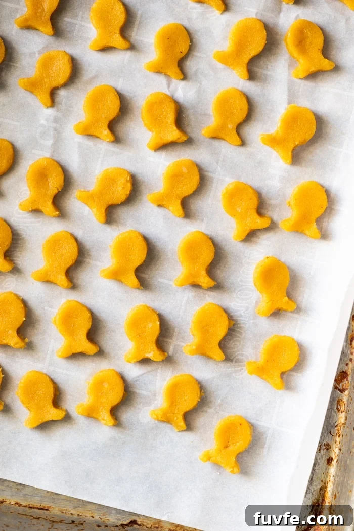 Unbaked keto goldfish crackers on parchment paper