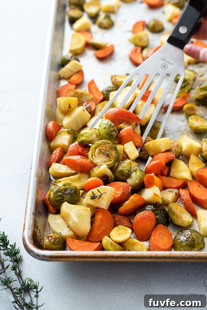 Roasted brussels sprouts carrots and parsnips on a sheet pan
