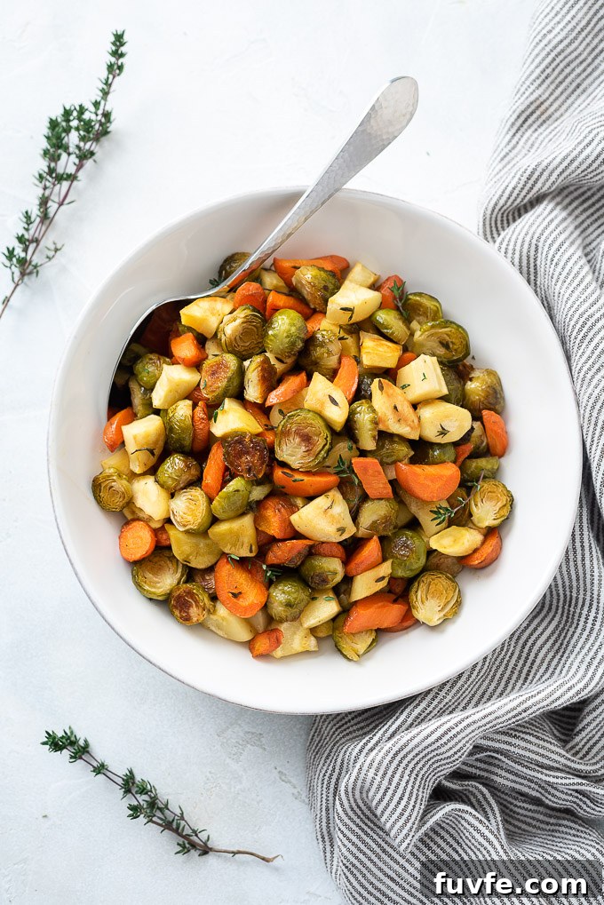 Roasted brussels sprouts and carrots in a bowl with thyme