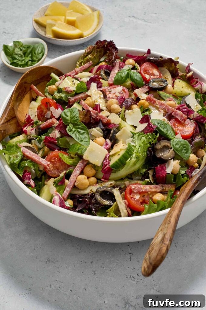 Classic Italian Chopped Salad Recipe with Zesty Vinaigrette 6 Chopped Italian salad in a white bowl with fresh basil.