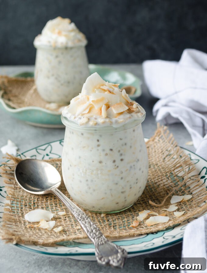 Coconut overnight oats in jars with coconut flakes on top.