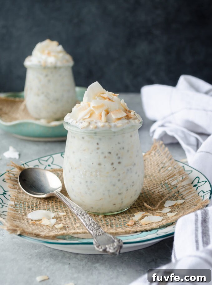 Coconut overnight oats in jars with coconut on top.