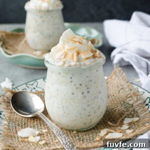 Coconut overnight oats in jars with coconut flakes on top.