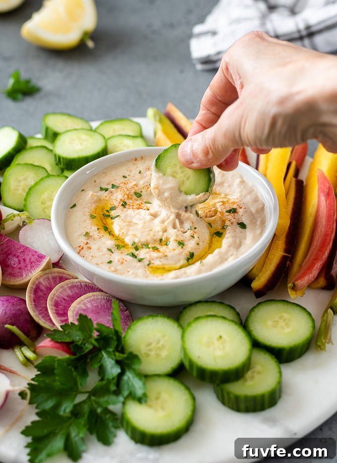 White bean hummus with cucumber dipping into the middle