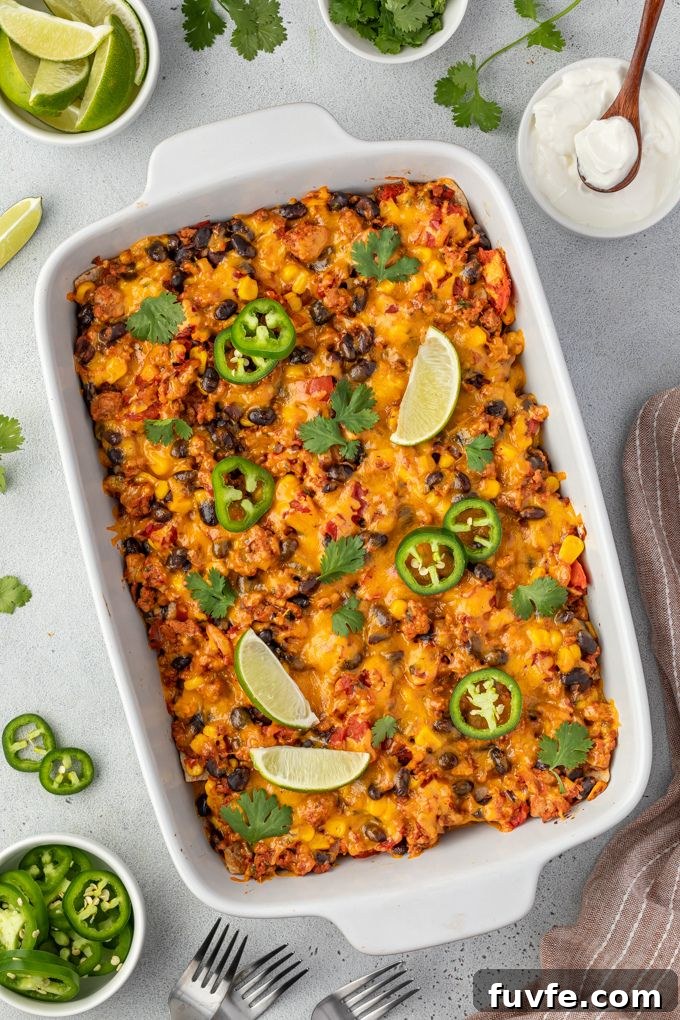 Cheesy Mexican Tortilla Casserole with Beans 3 Mexican tortilla casserole in baking dish with jalapeno and lime