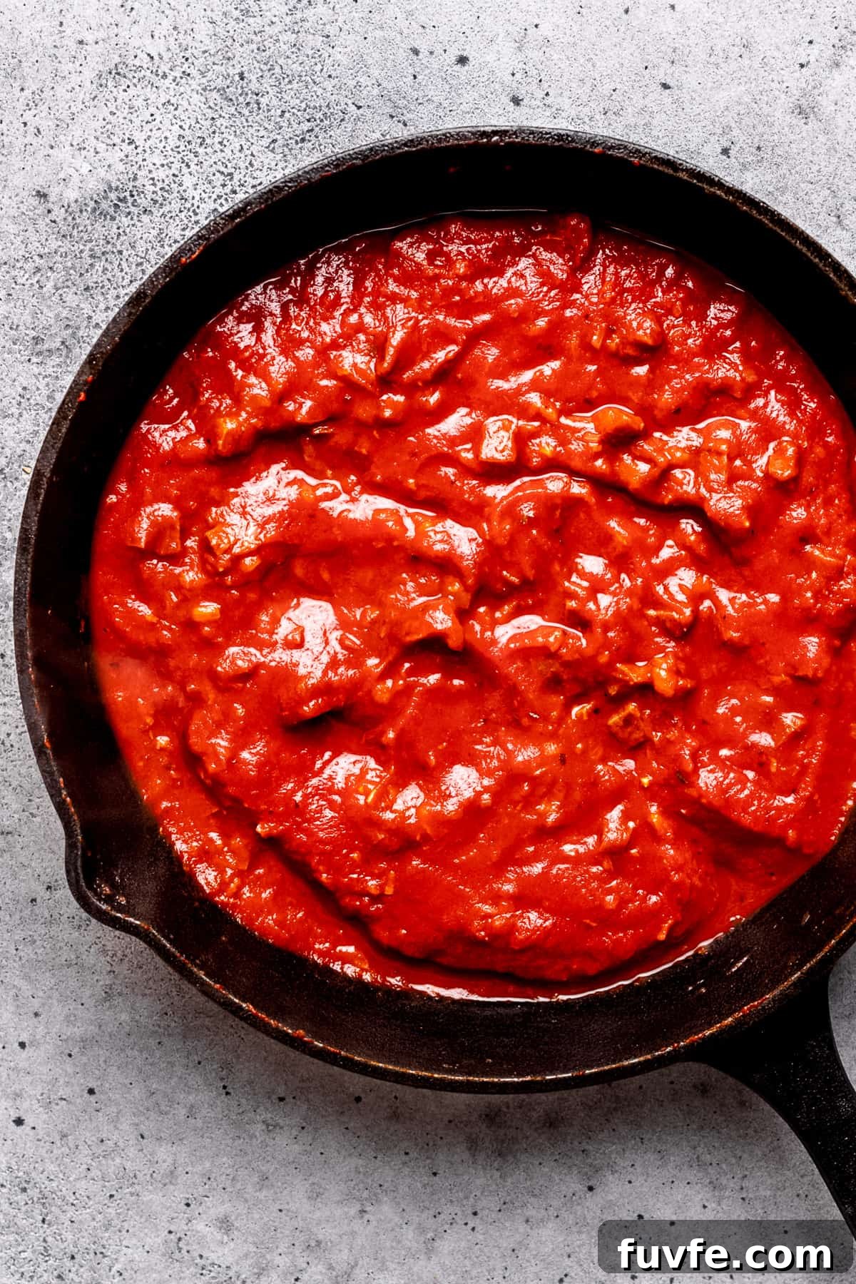 Tomato sauce in a pan with chorizo.