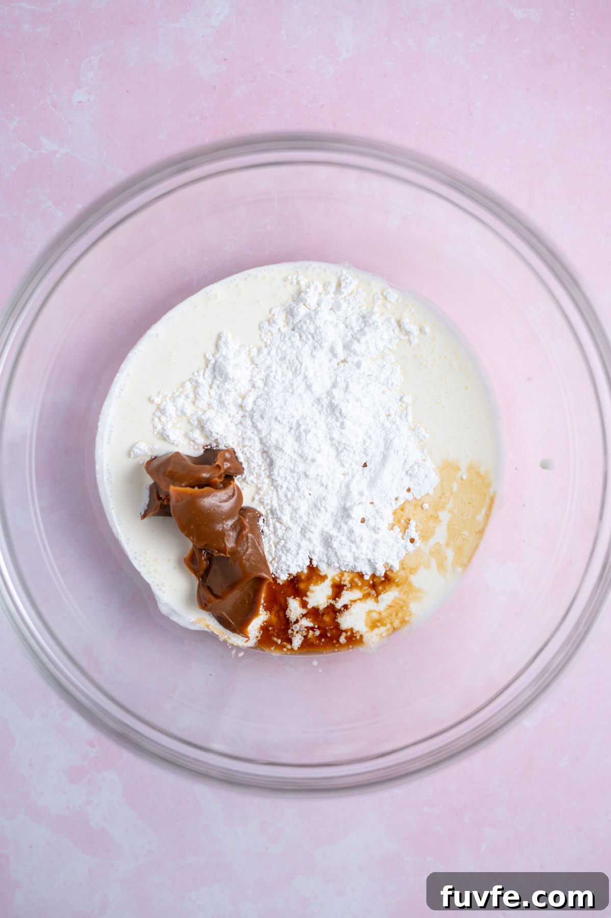 Decadent Banoffee Cake Recipe with Caramelized Banana Layers 13 dulce de leche whipped cream ingredients in a glass bowl