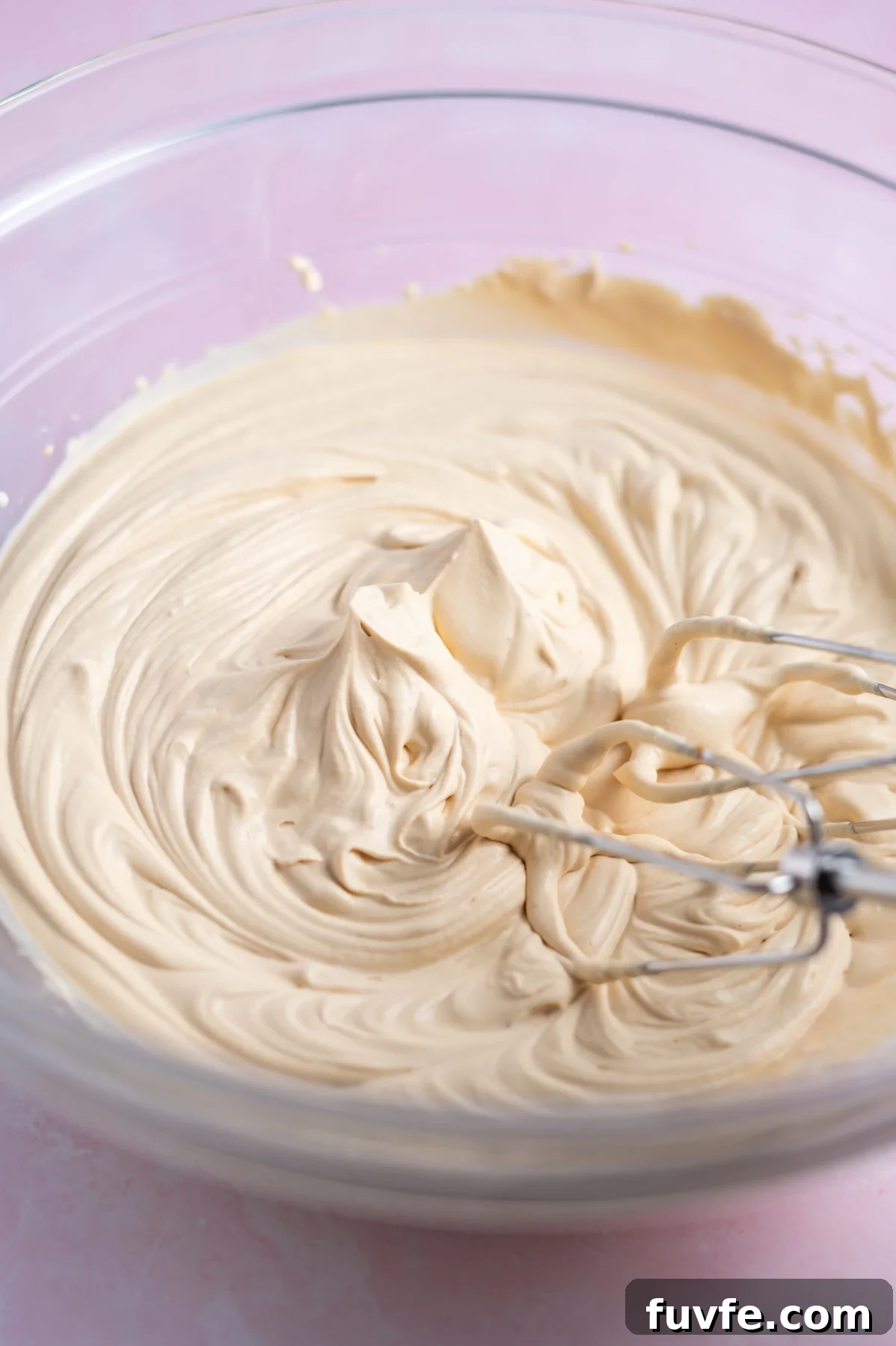 Decadent Banoffee Cake Recipe with Caramelized Banana Layers 14 toffee whipped cream in a mixing bowl with the beaters